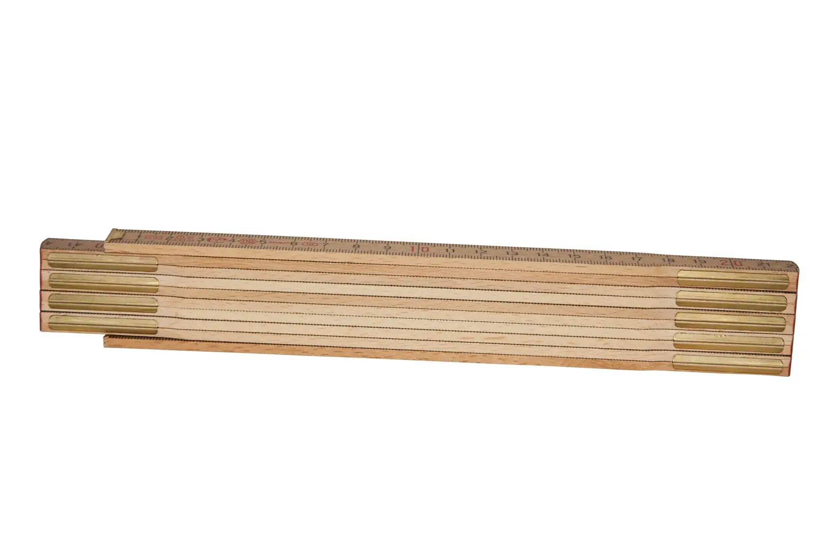Wooden folding ruler with brass joints, closed and laid flat on a white background.
