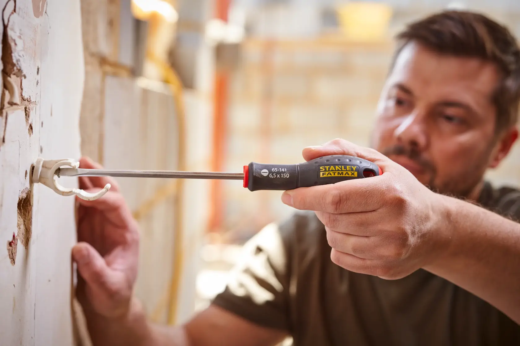 STANLEY® FATMAX® Slotted Flared 6.5 x 150mm Screwdriver Application Action Shot Hand/Person