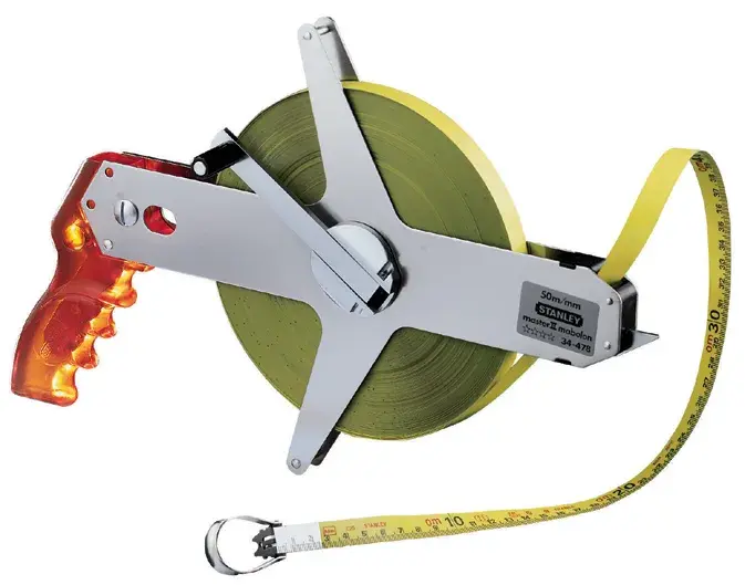 STANLEY 1-34-477 open reel fiberglass tape measure, yellow and silver, side angle on white background.
