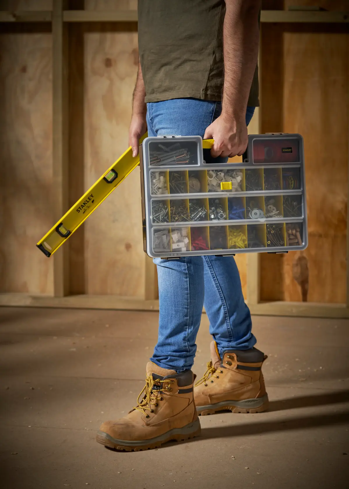 STANLEY 1-92-762 organizer box with yellow handle, held beside a yellow level, photo of person standing.