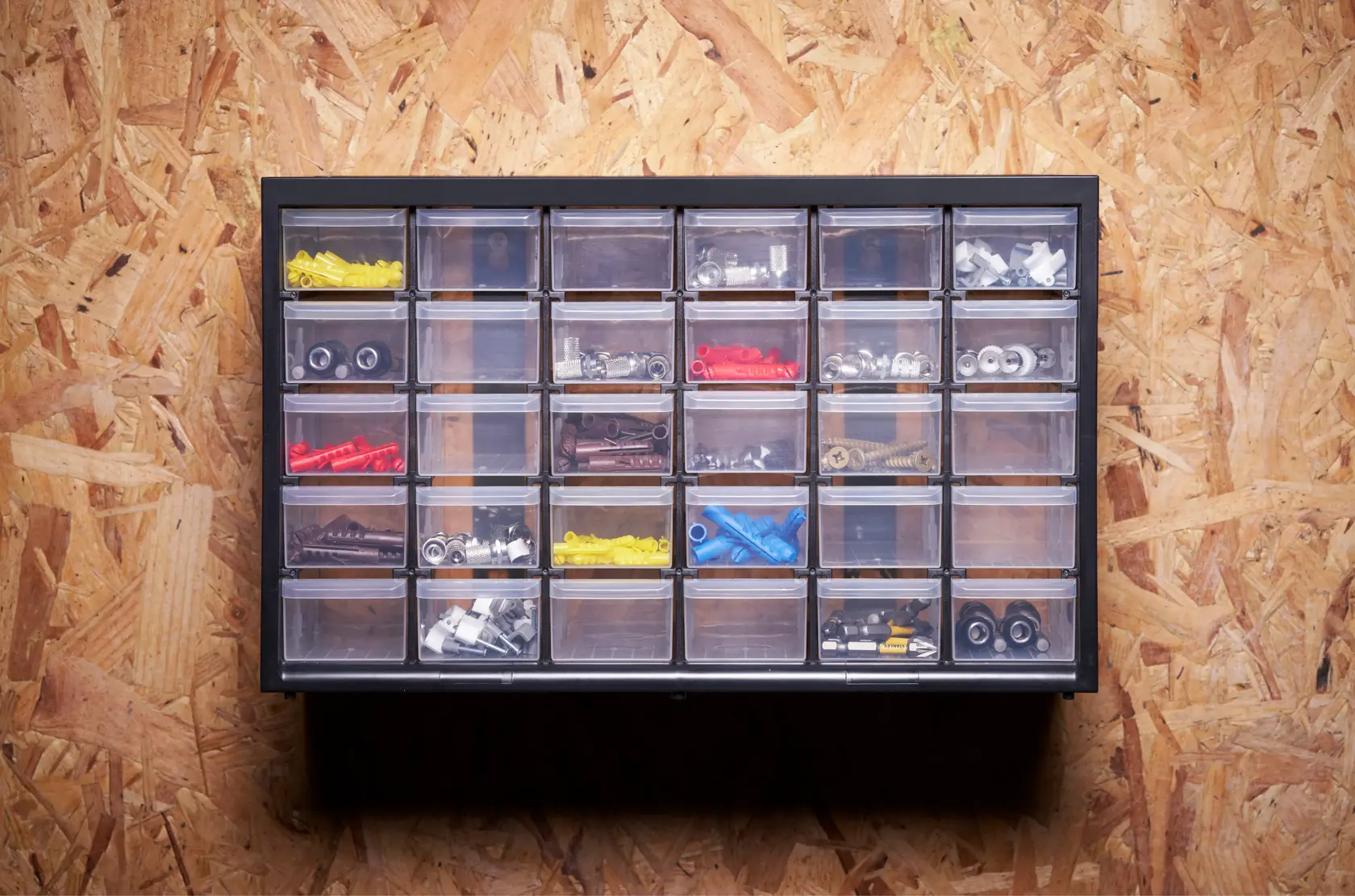 STANLEY 1-93-980 organizer with 24 clear drawers holding assorted hardware, wall mounted front view.