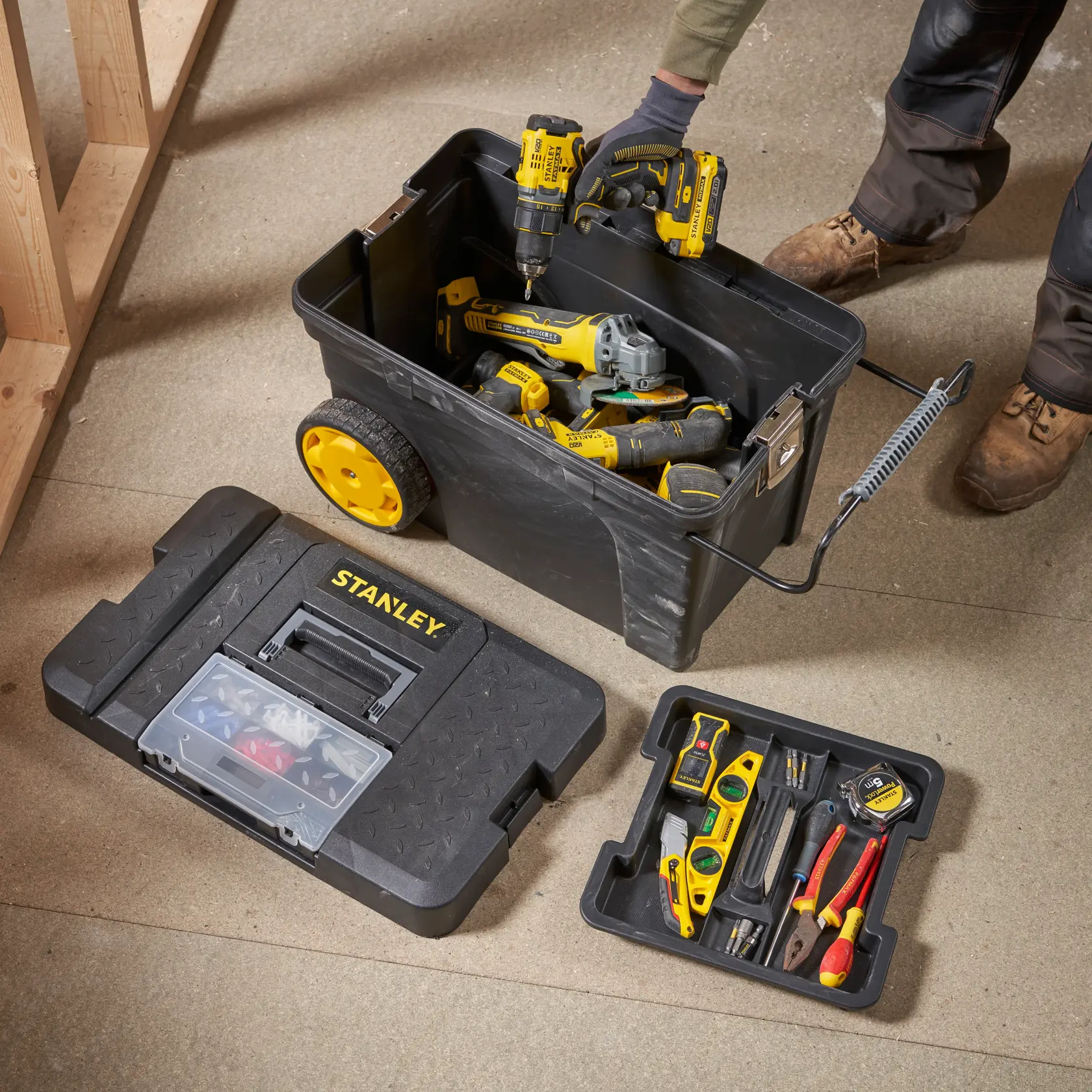 STANLEY 1-97-503 tool box photography with yellow wheels and assorted hand and power tools inside.