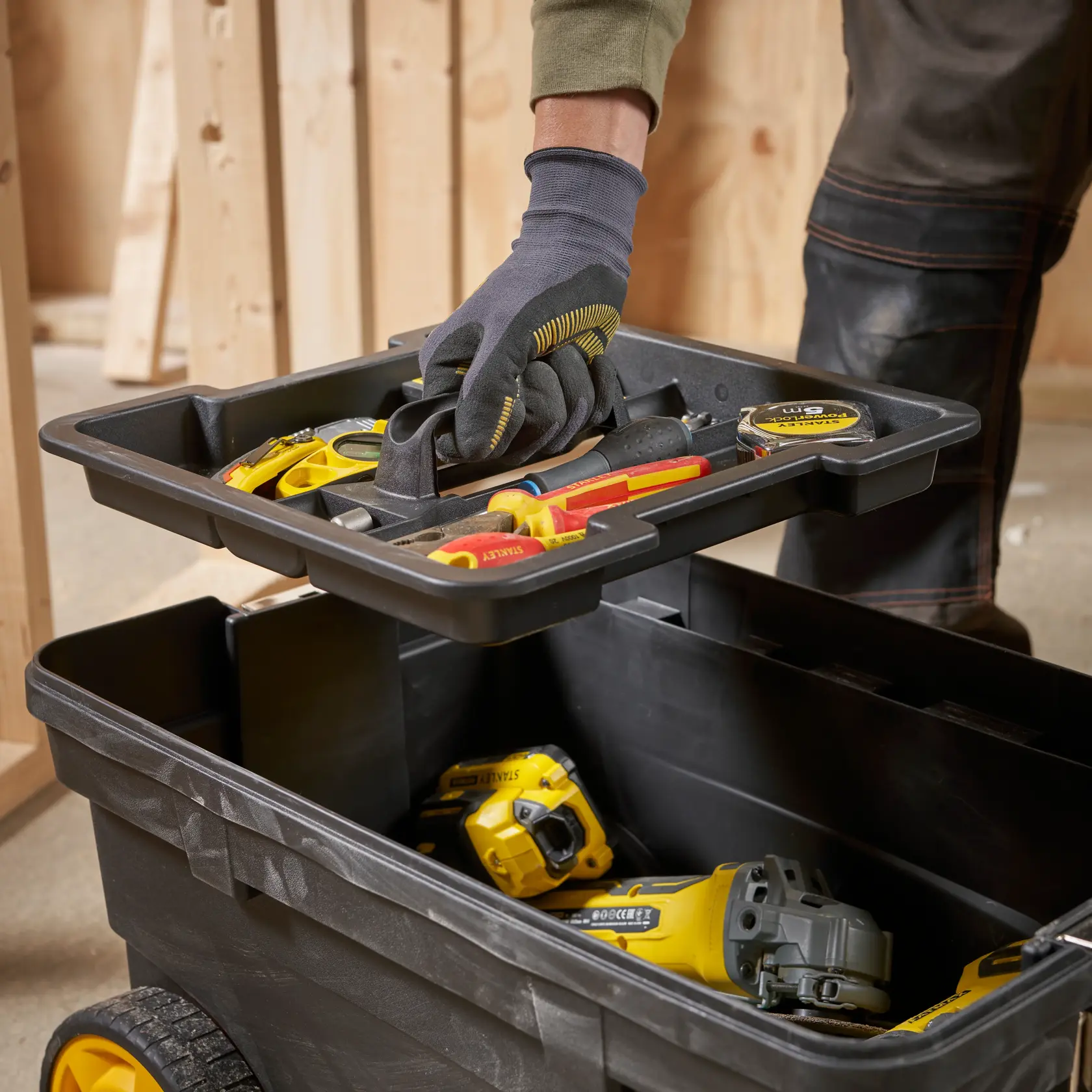 STANLEY 1-97-503 tool box with removable tray, filled with hand tools and power tools, close-up angle.