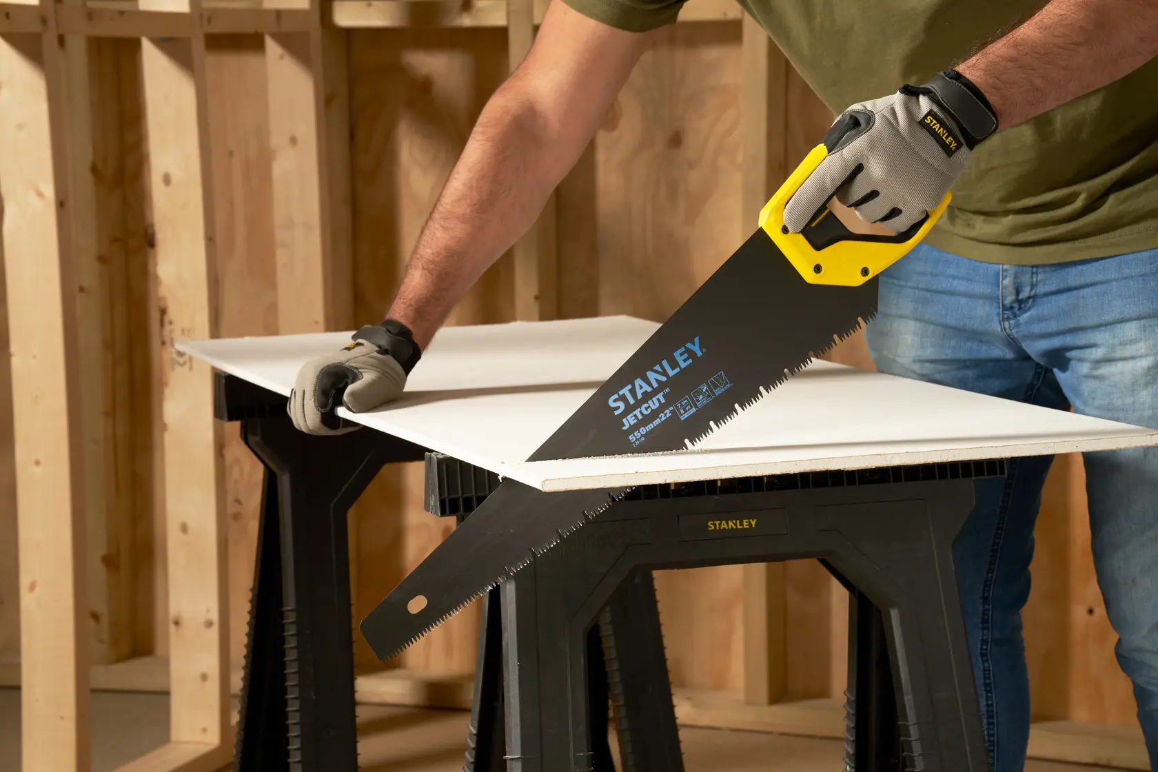 STANLEY 2-20-149 hand saw cutting board on workbench, close-up, yellow and black handle, photography.