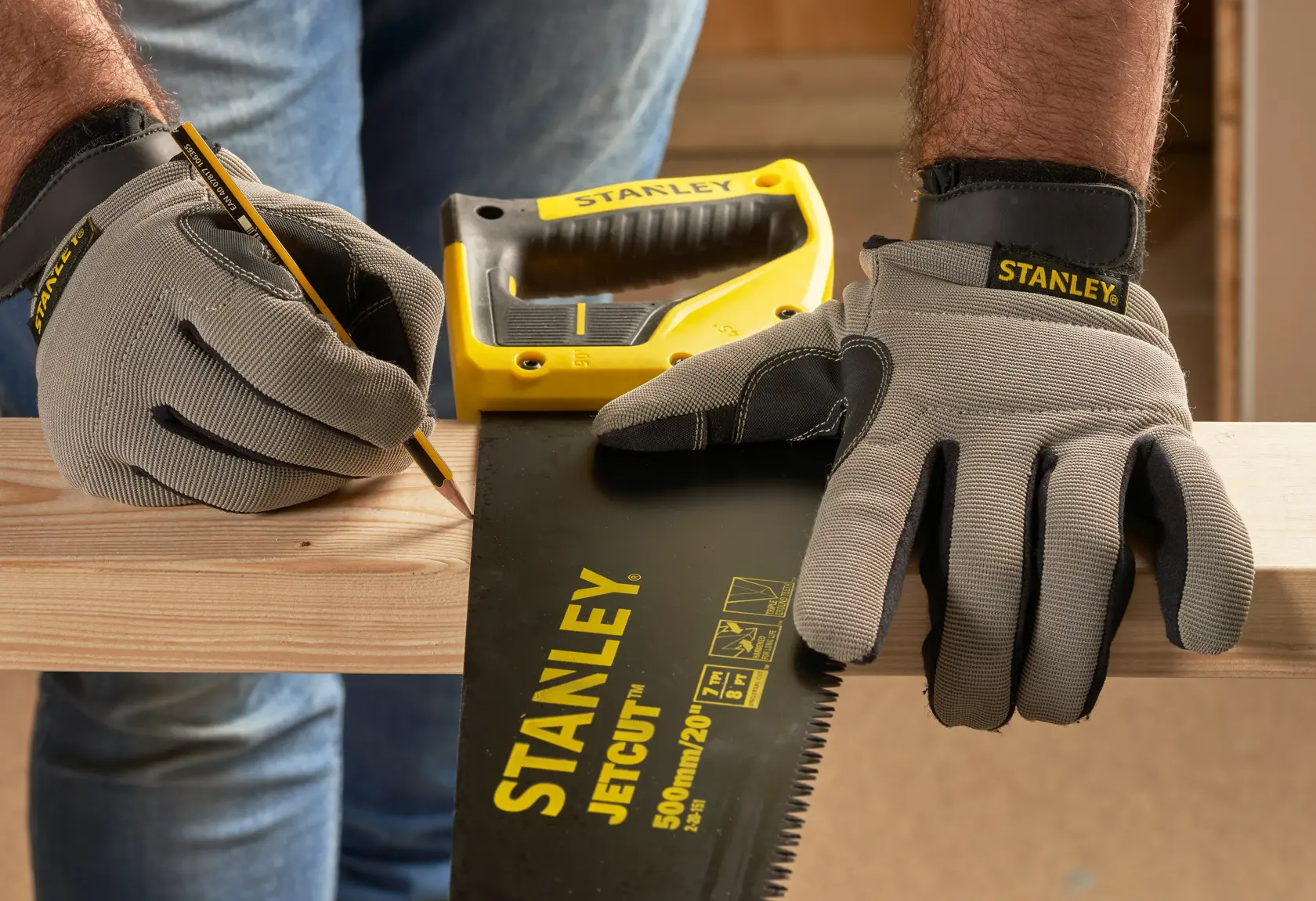STANLEY 2-20-151 hand saw and gloves marking wood, close-up photography.