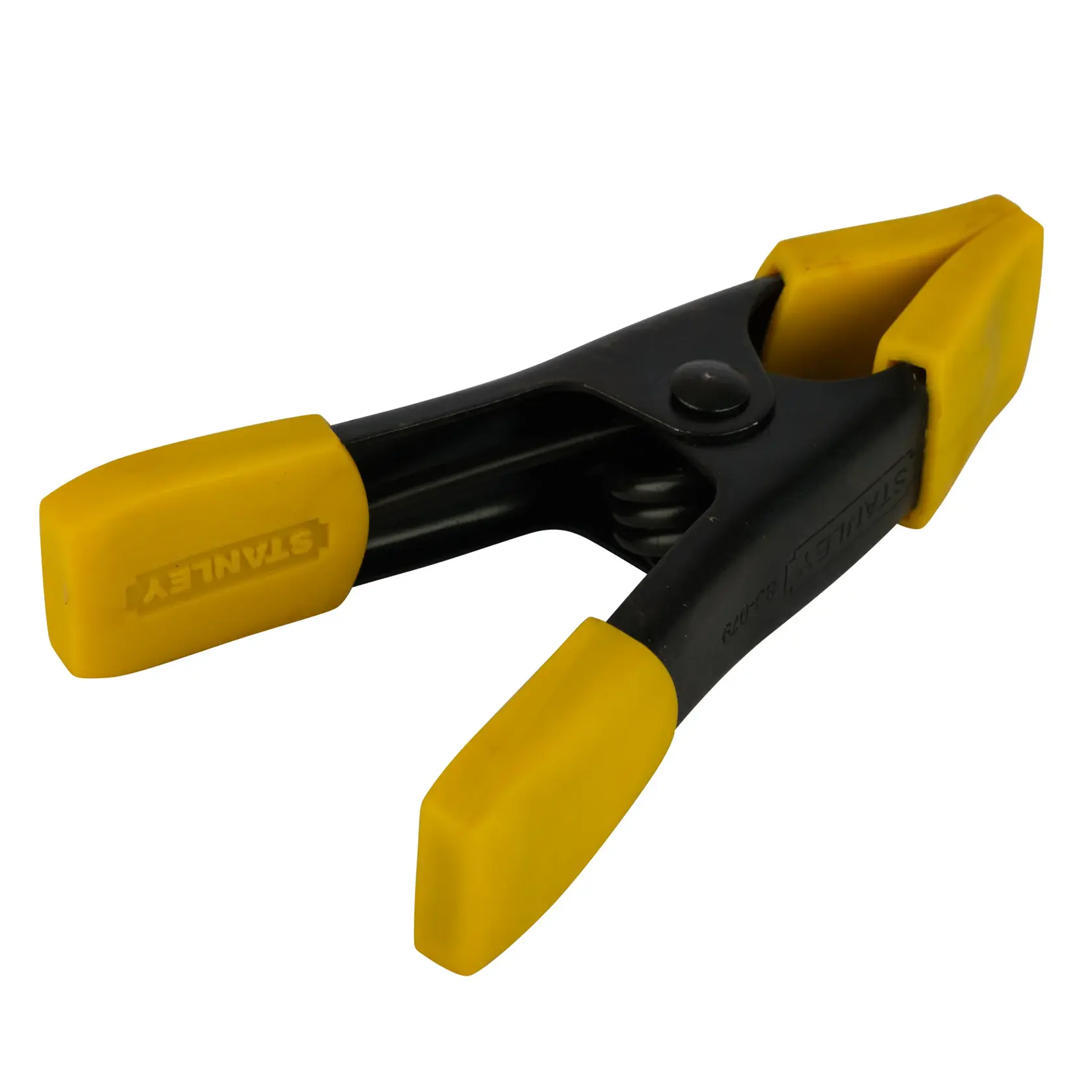 Stanley spring clamp with yellow plastic grips, used for holding items securely during photography or crafts.