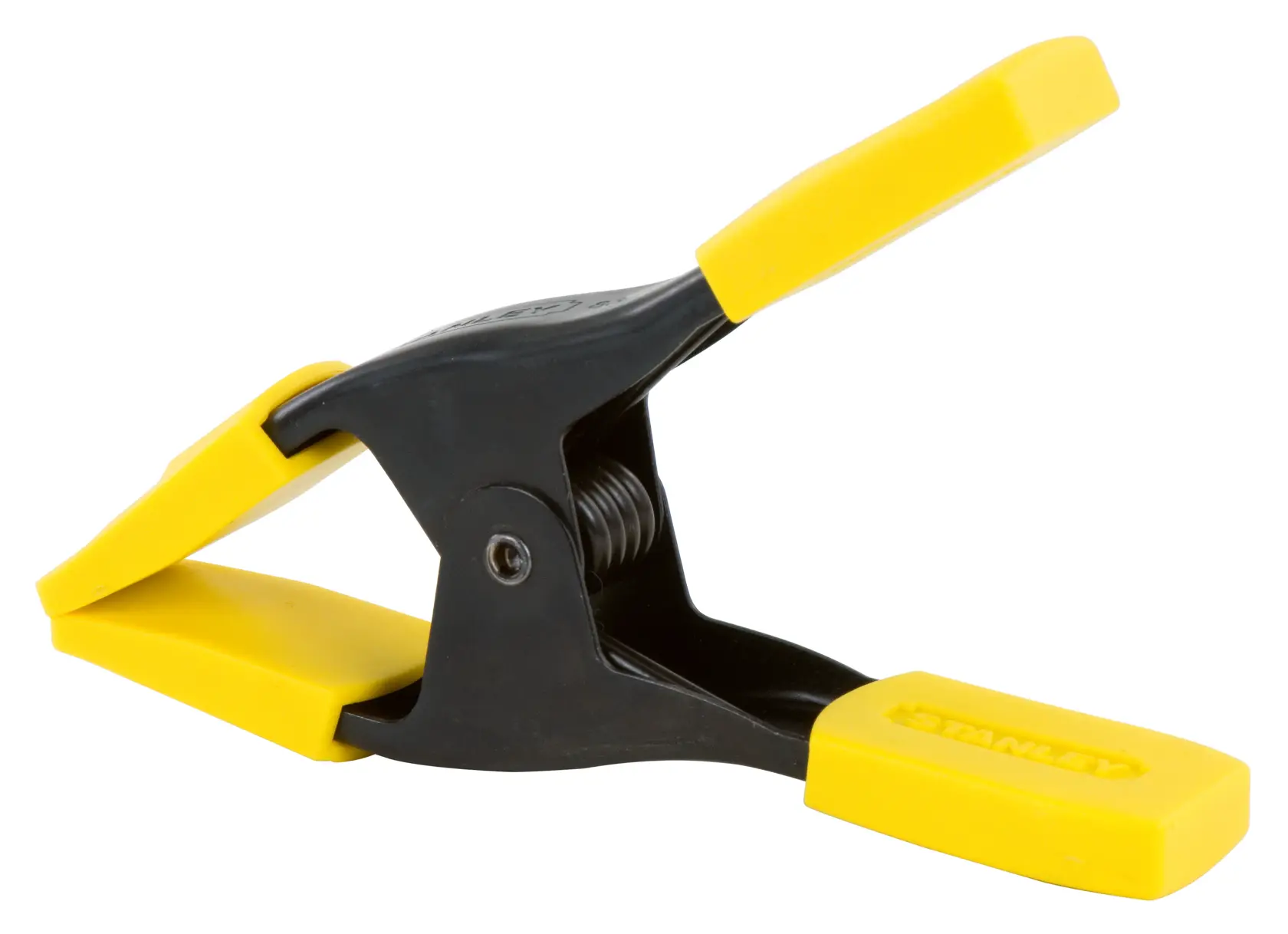 Stanley spring clamp with black body and yellow handles, used for securing items in photography and DIY.