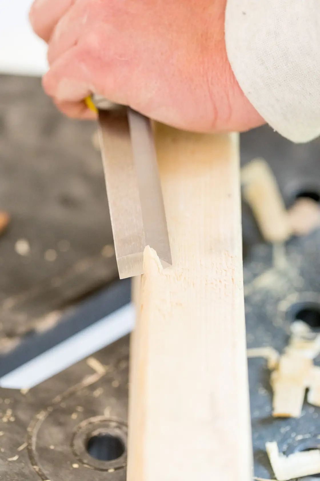 STANLEY FMHT16693-0 woodworking chisel in use, close-up view carving light wood.