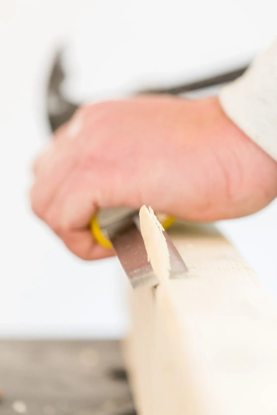 STANLEY FMHT16693-0 chisel cutting wood, close-up photography of hand tool in use.