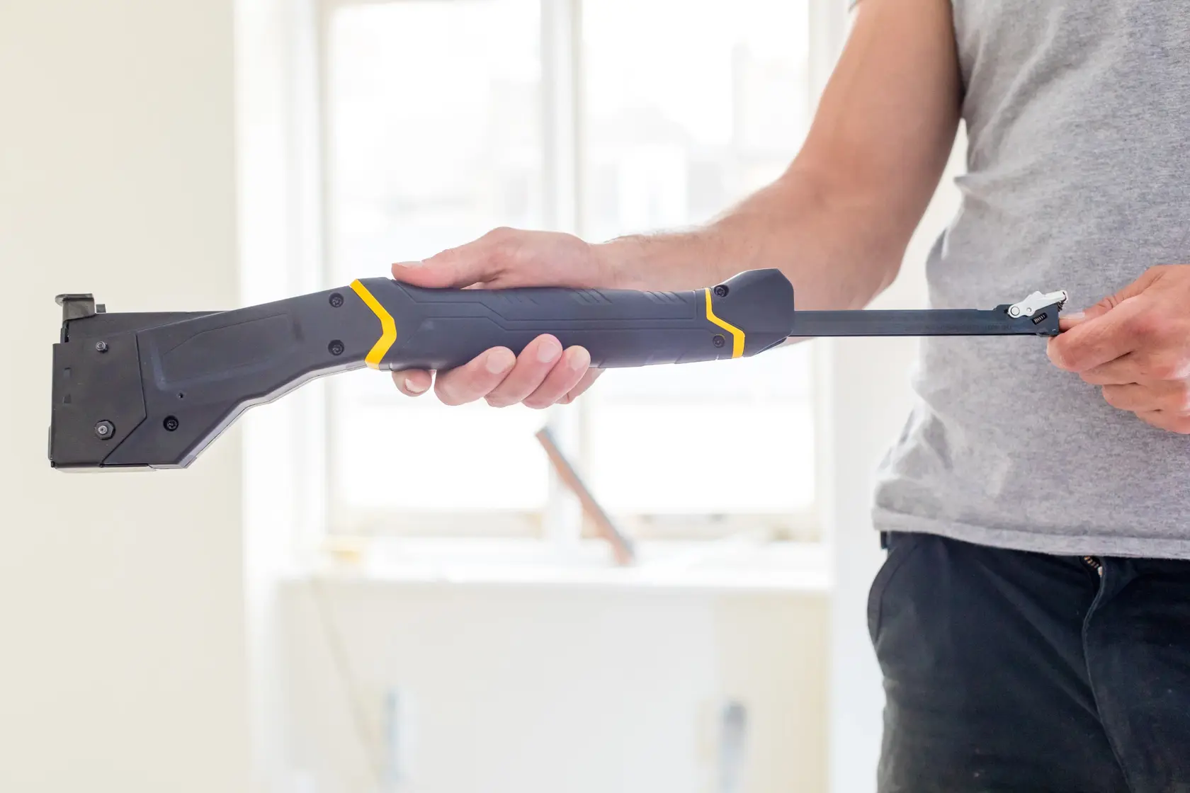 Photo of STANLEY FMHT81394-9 drywall carrier tool being held by a person indoors.