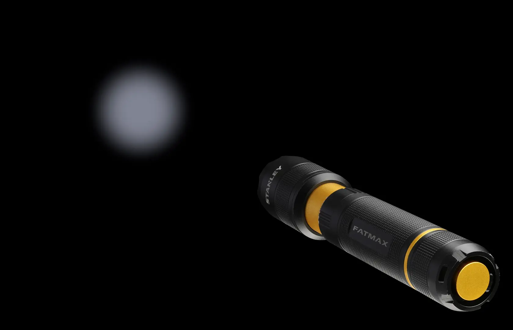 STANLEY FMHT81511-0 black and yellow flashlight side angle with beam visible in darkness.