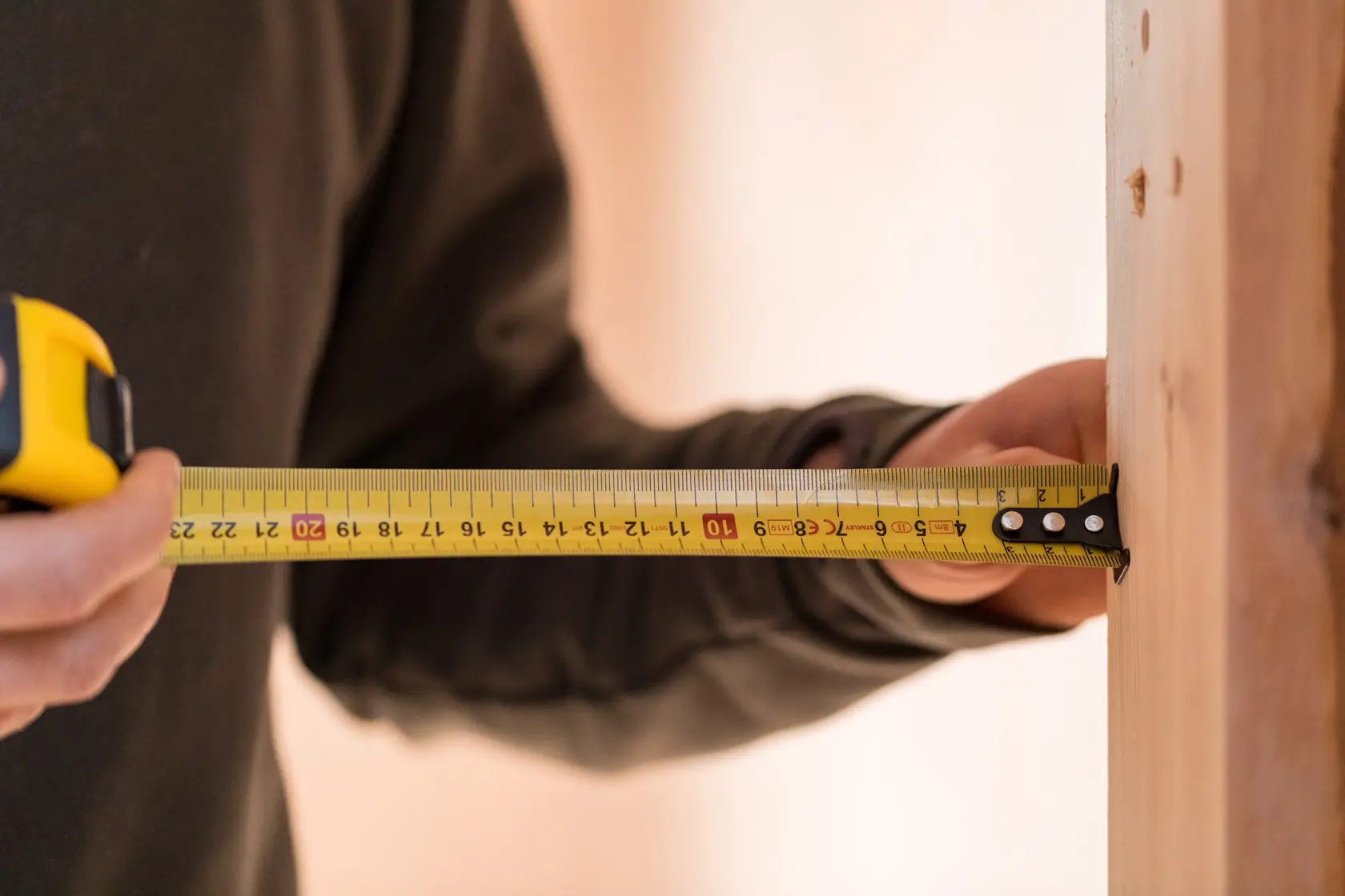 STANLEY FMHT81555-0 tape measure photography showing yellow tape measuring wood.