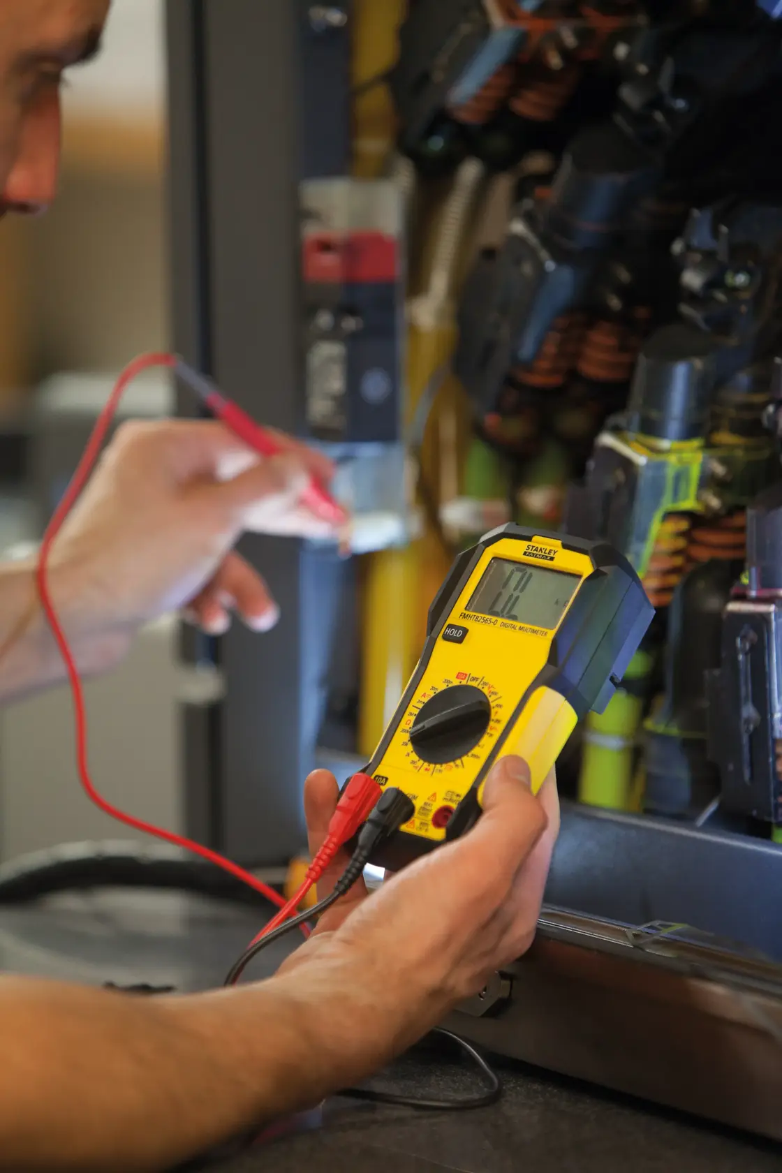 Photo of STANLEY FMHT82565-0 digital multimeter being used to test electrical panel wiring.
