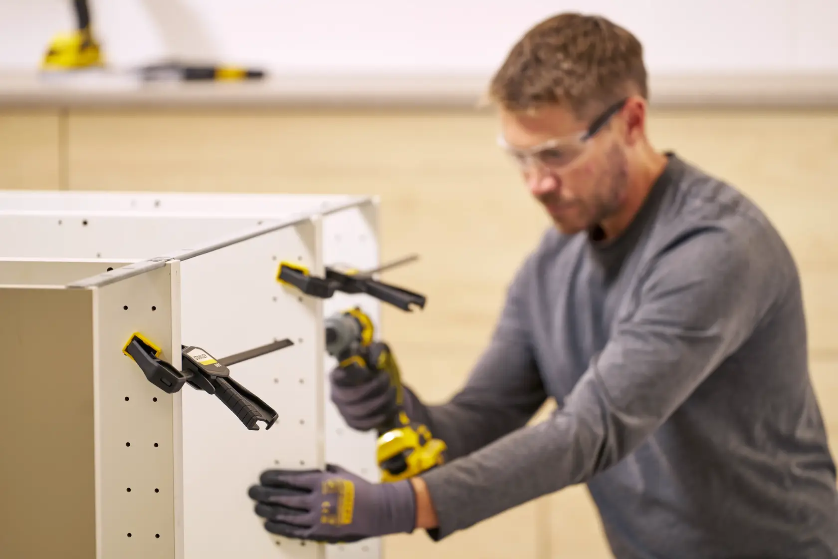 STANLEY FMHT83272-0 photography of bar clamps securing cabinet panels during assembly.