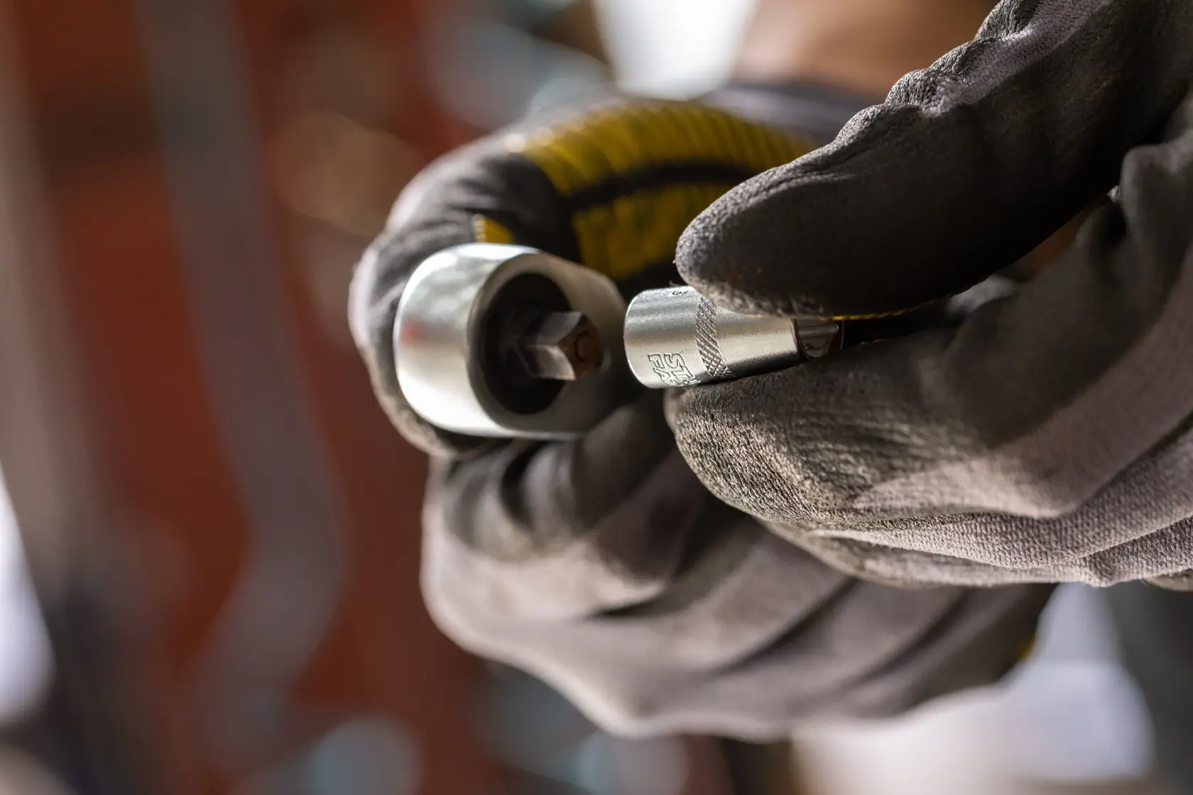 Photo of STANLEY FMMT17185-0 socket being held with gloves, close-up, tool category.