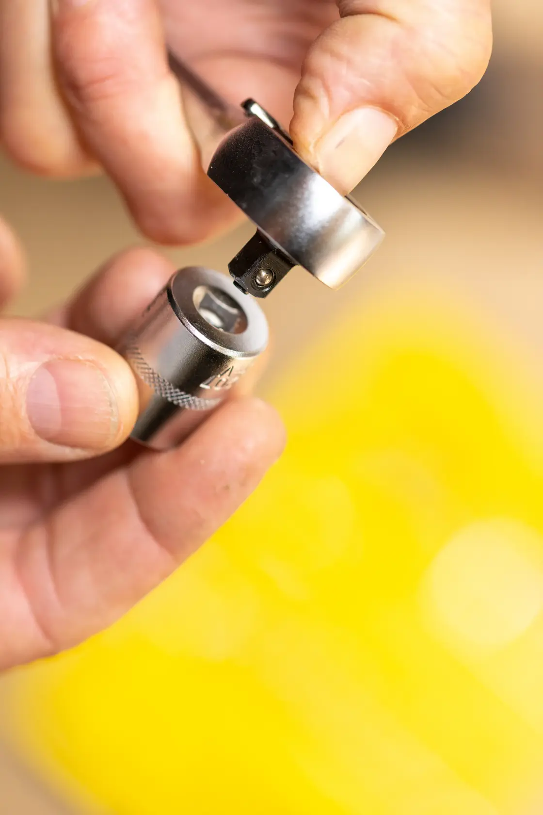 STANLEY FMMT17185-0 socket wrench adapter held by hand, close-up photography.