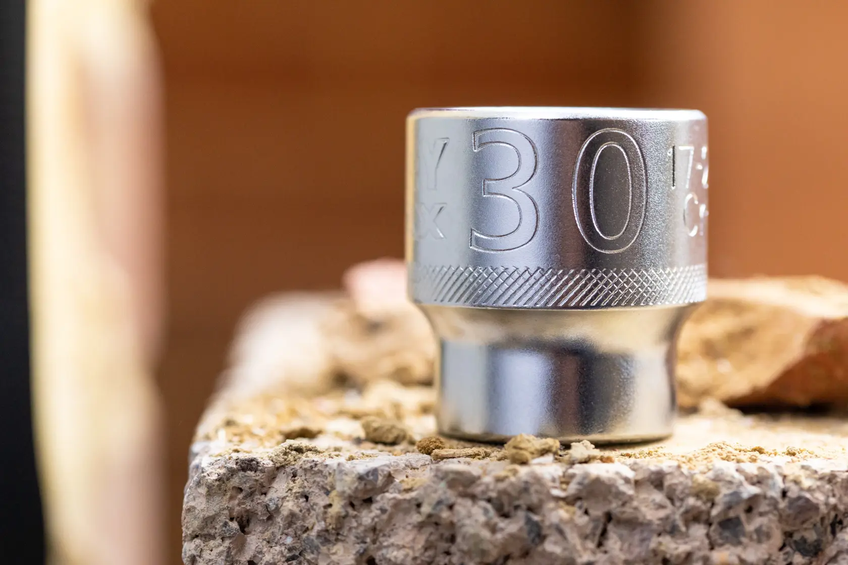 STANLEY FMMT17208-0 chrome socket 30mm, close-up on rocky surface, product photography.
