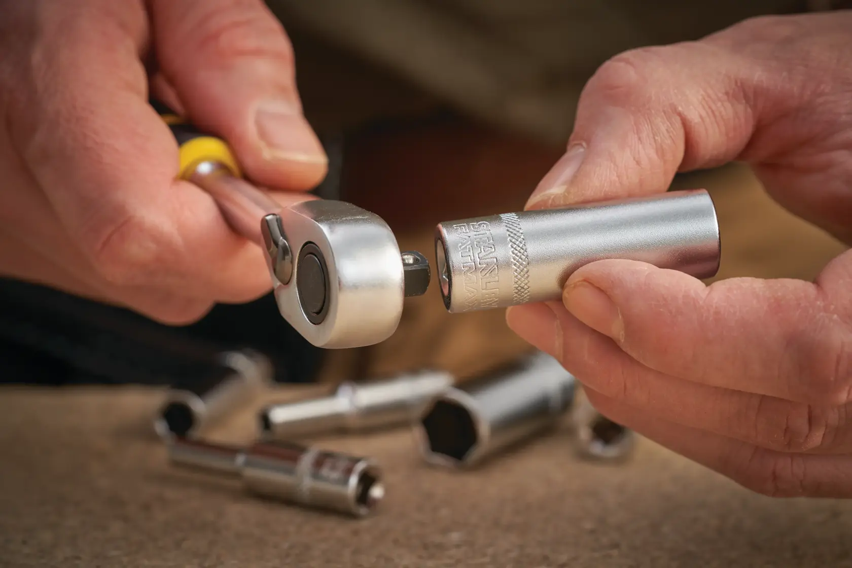Photo of STANLEY FMMT17249-0 socket being attached to ratchet wrench, other sockets in background.