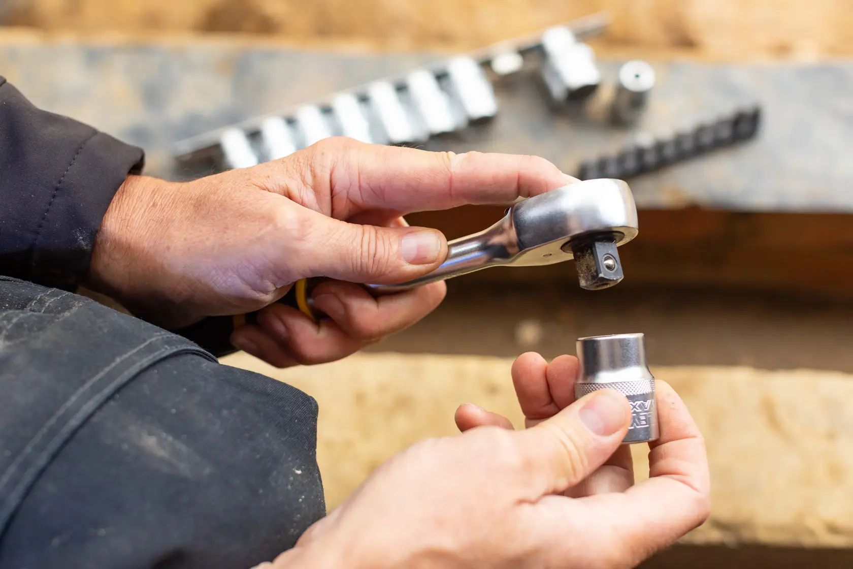 STANLEY FMMT82680-0 socket wrench set in use, close-up of hands holding ratchet and socket.