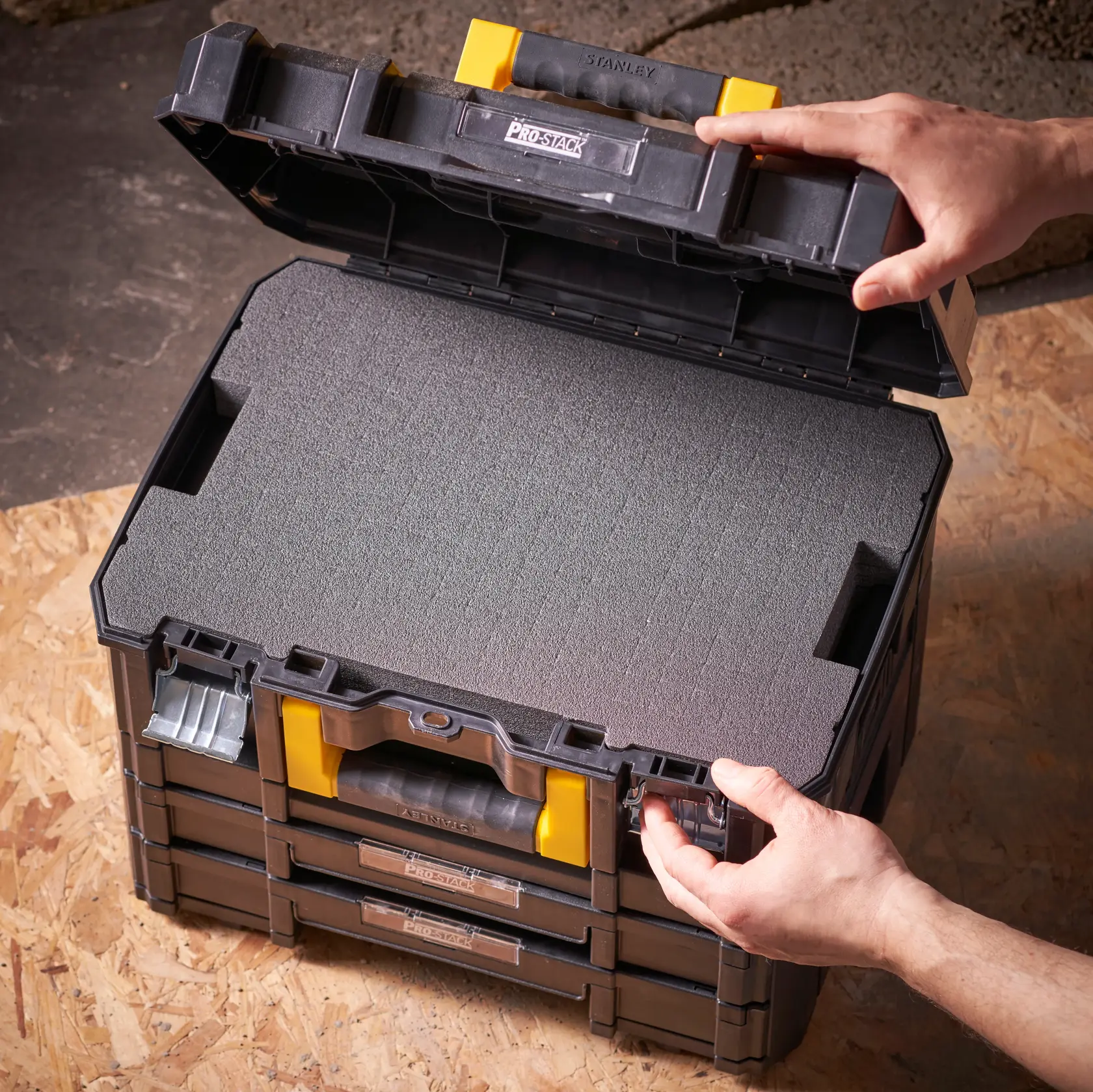 STANLEY FMST1-72365 modular storage box with foam insert, shown open from above on a wooden surface.