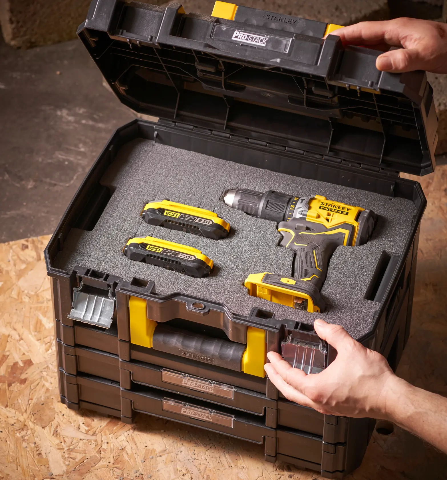 STANLEY FMST1-72365 ProStack toolbox open with yellow-black drill and two batteries in foam insert.