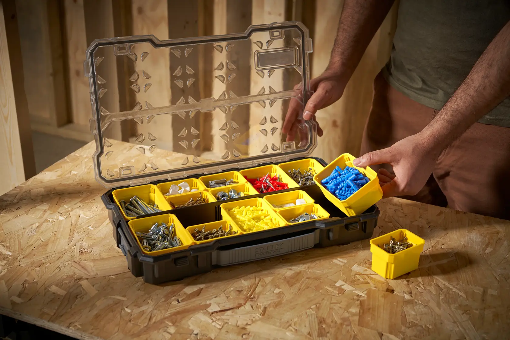 STANLEY FMST1-75779 organizer box with yellow compartments holding various screws and fasteners, photo at angle.