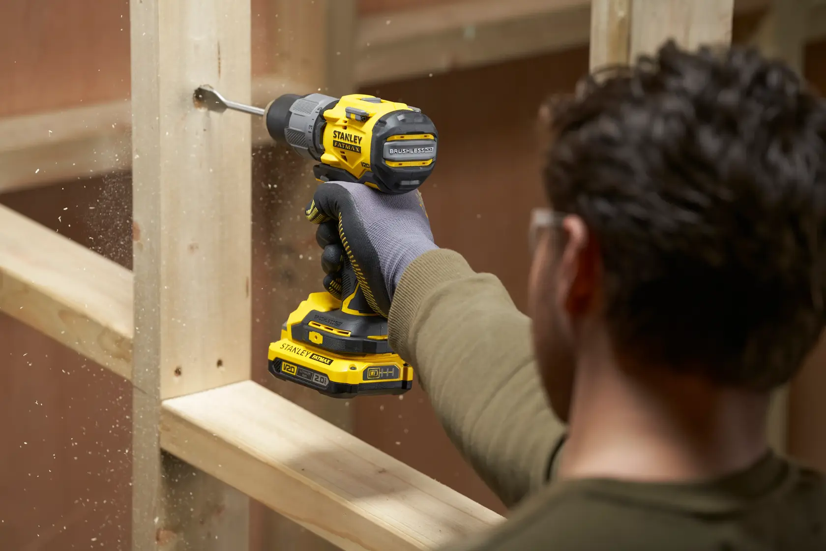 Photo of STANLEY SFMCD726D2K cordless drill being used to drill into wooden frame.