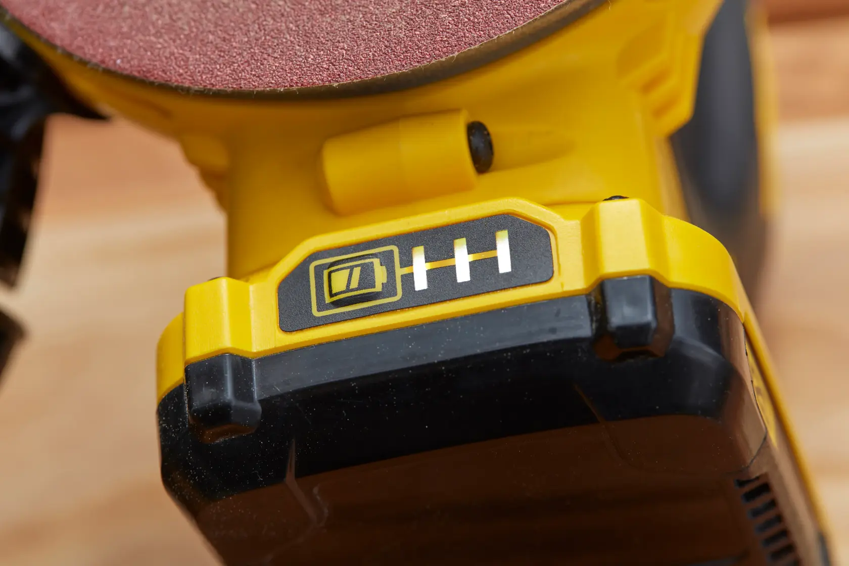 STANLEY SFMCW220D1S cordless sander battery indicator close-up, yellow and black body, photography.
