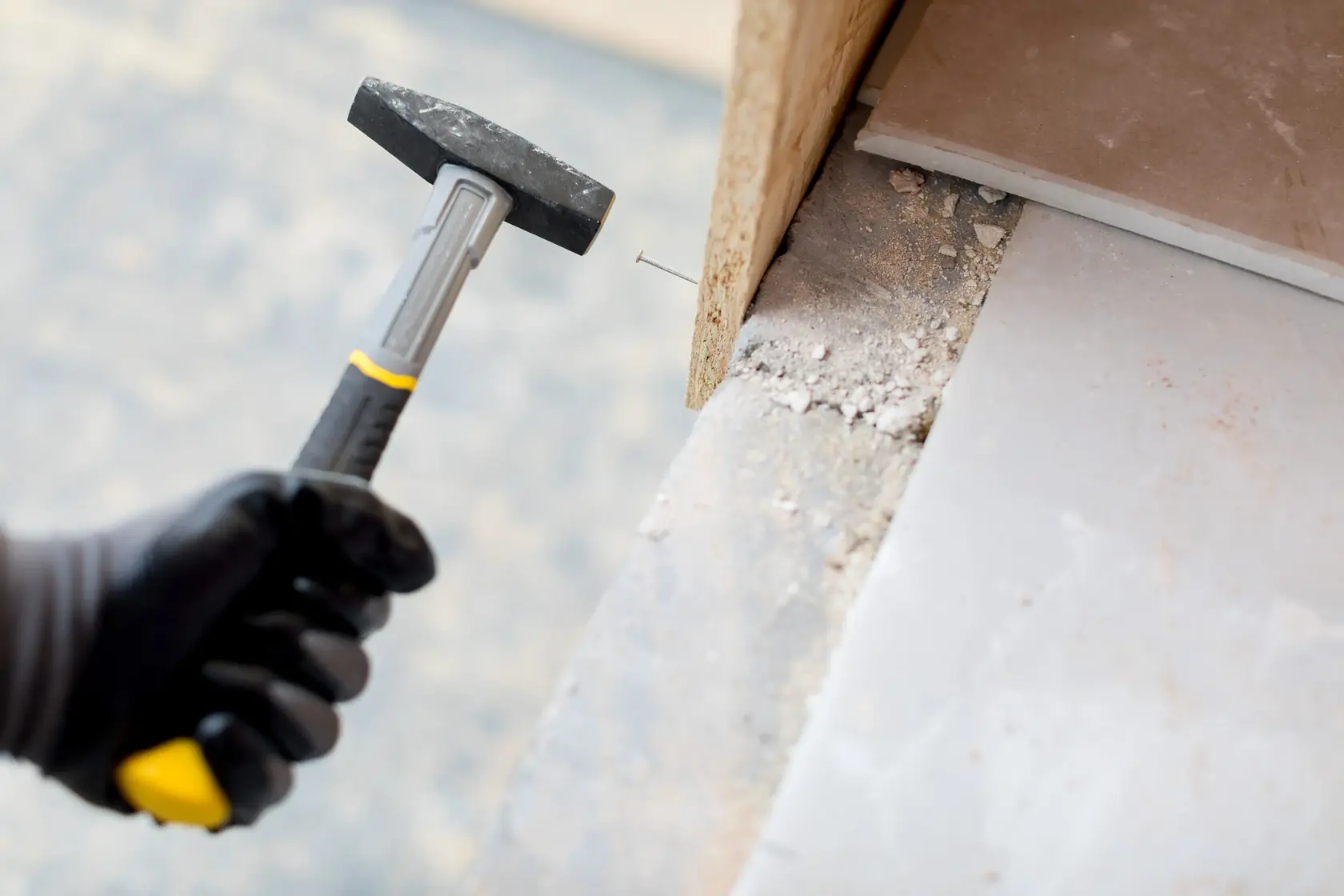 Photo of STANLEY STHT0-51907 club hammer with black handle driving nail into wood.