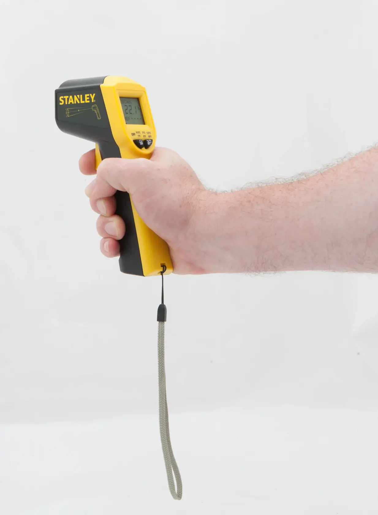 STANLEY STHT0-77365 infrared thermometer with display, yellow and black, shown in hand, side angle.