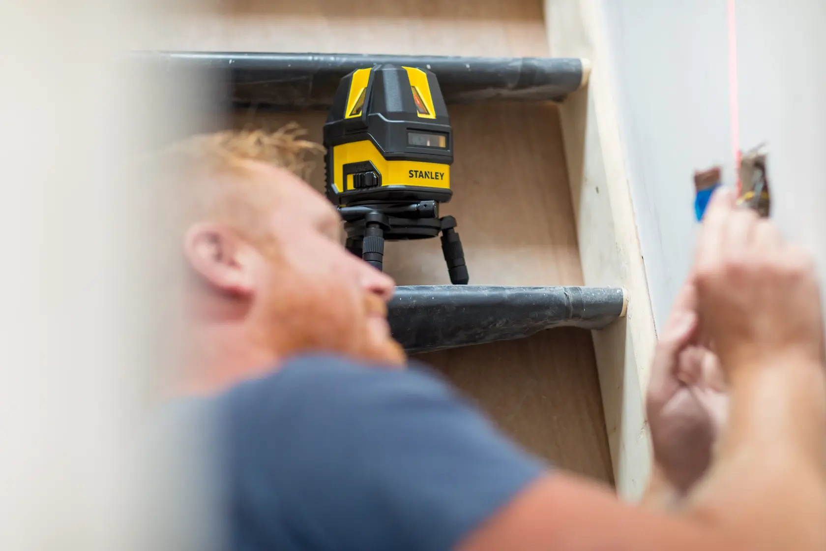 STANLEY STHT77514-1 laser level tool used for wall alignment in construction, photography category.