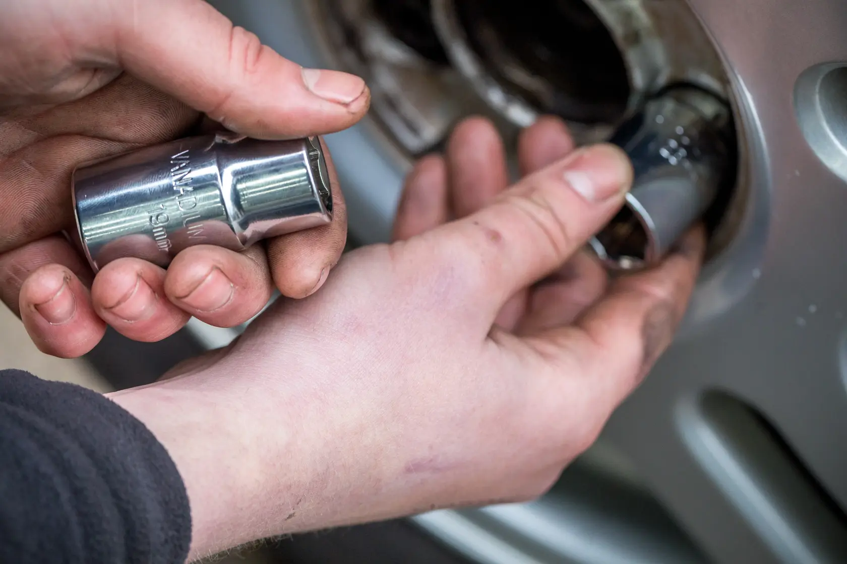 Photo of STANLEY STHT80890-0 socket being used to remove a lug nut from a vehicle wheel.