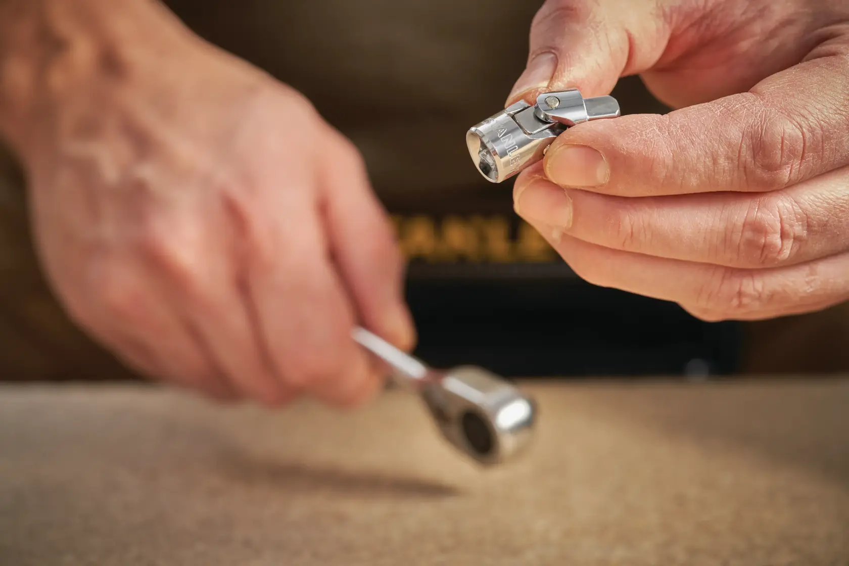 STANLEY STMT86011-0 socket wrench tool held in hand, close-up on metal joint, photography product.