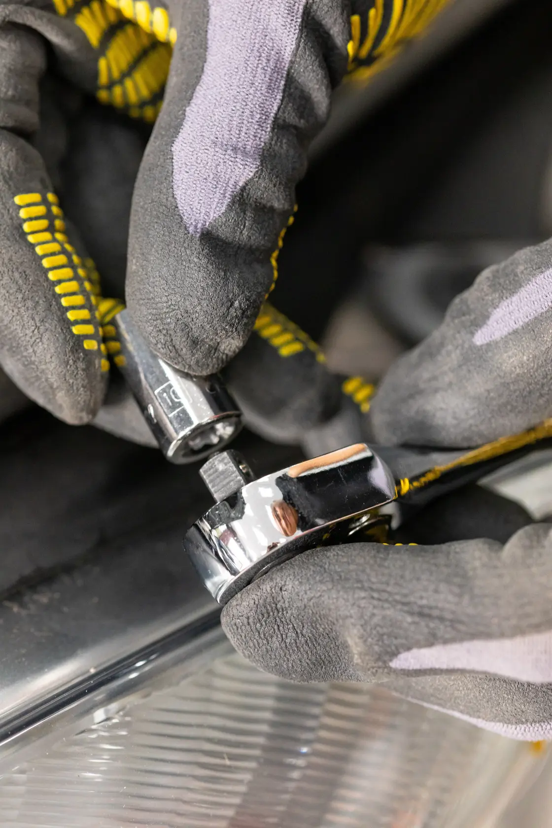 STANLEY STMT86108-0 socket and ratchet in use, close-up with gloved hands, automotive context.