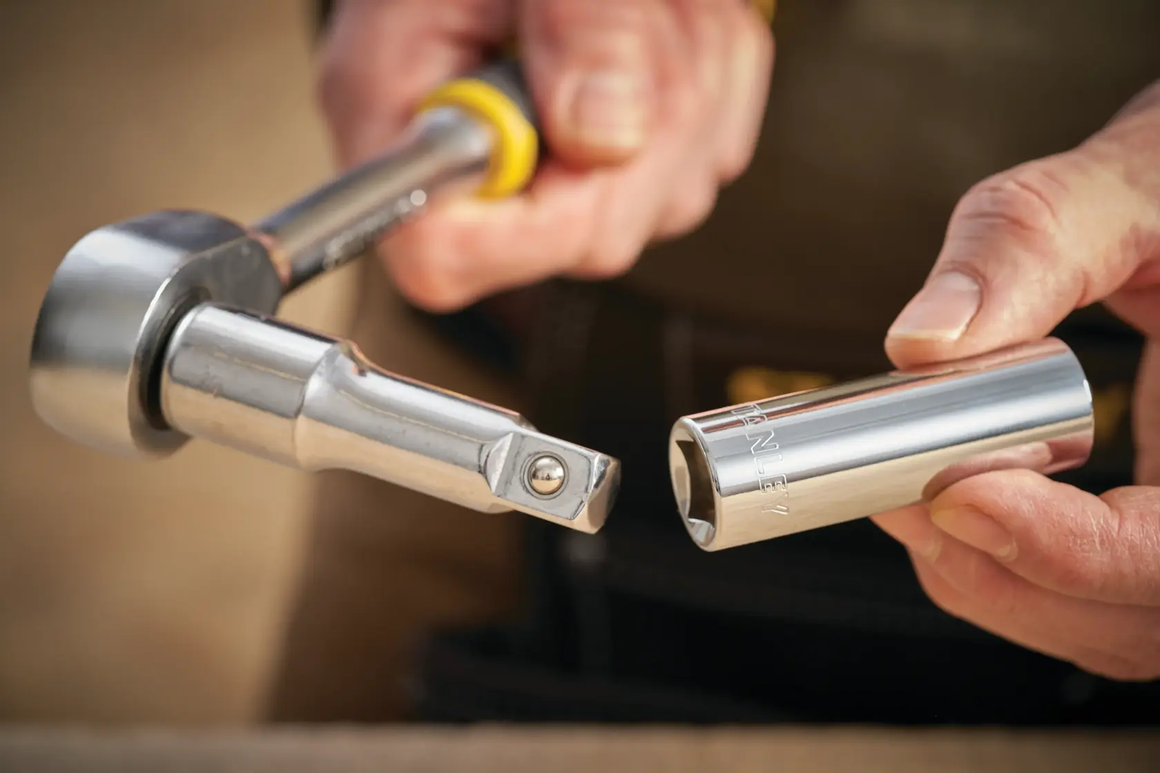STANLEY STMT88993-0 socket wrench and socket held in hand, close-up photography.
