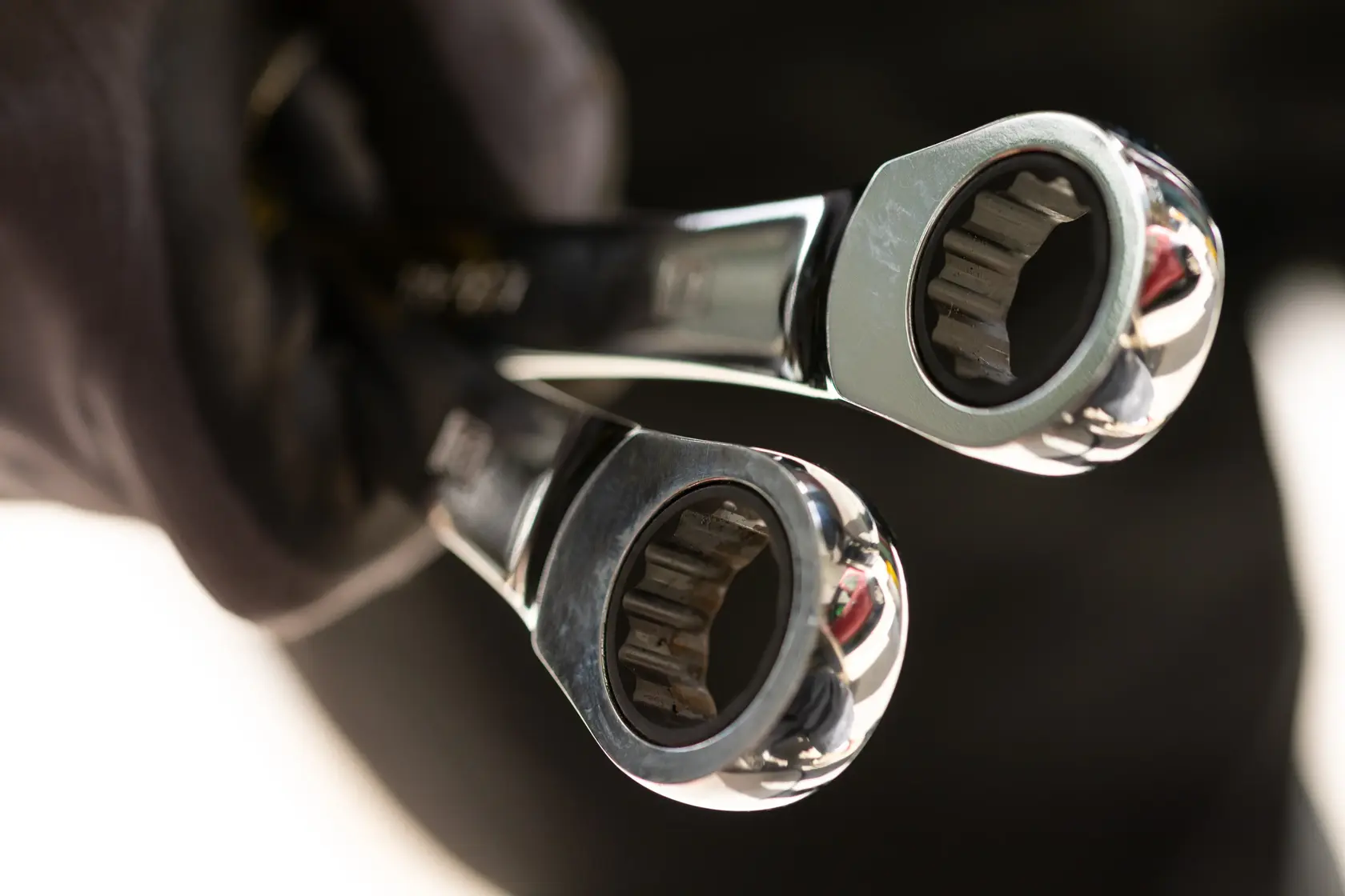 STANLEY STMT89913-0 ratcheting wrenches held in gloved hand, close-up photography of tool heads.