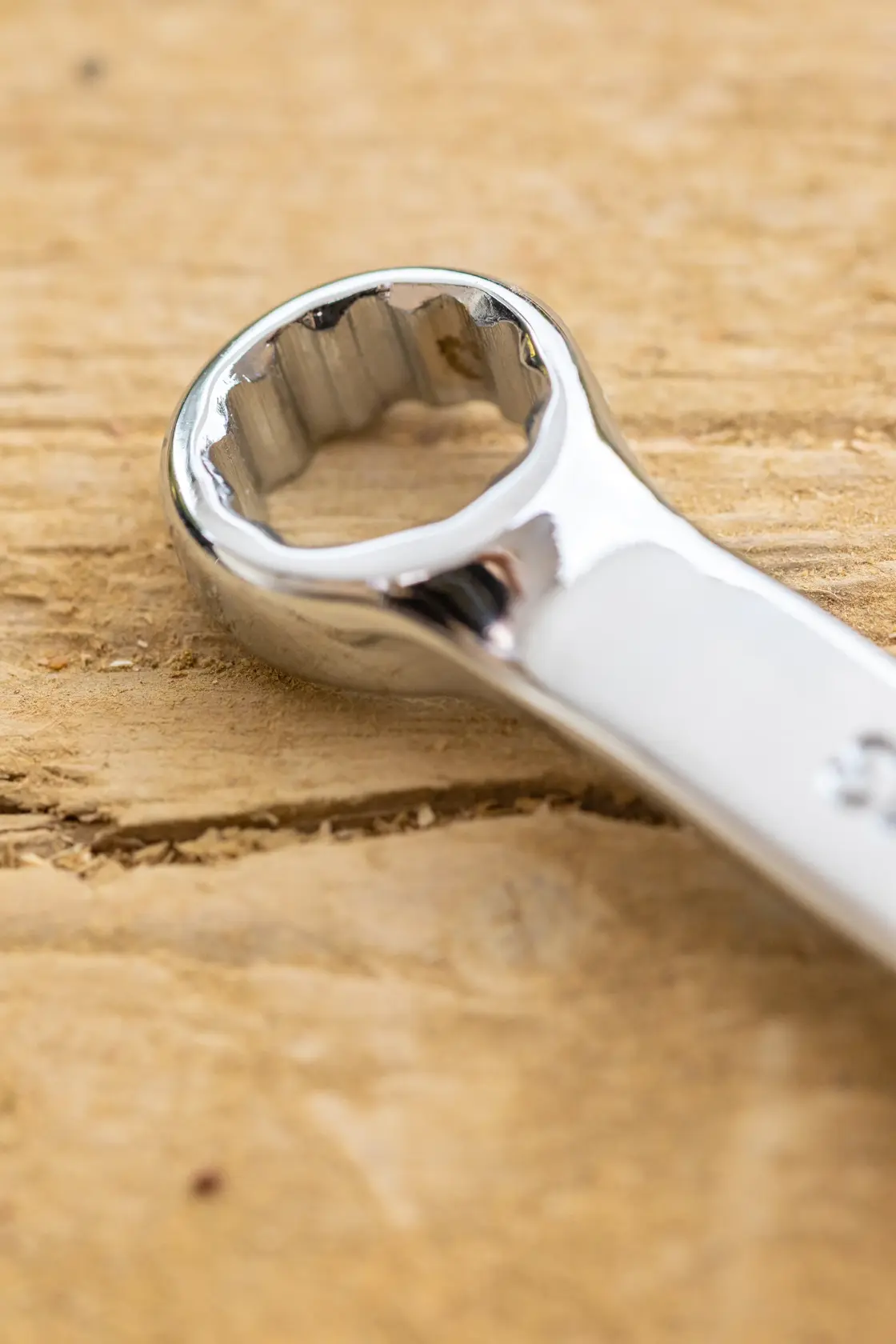 STANLEY STMT95787-0 photography of chrome box-end wrench on wooden surface, close-up angle.