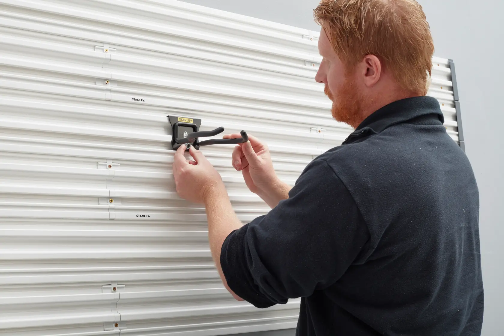 Photo of STANLEY STST82609-1 hook installed on slat wall panel in use, category Photography.