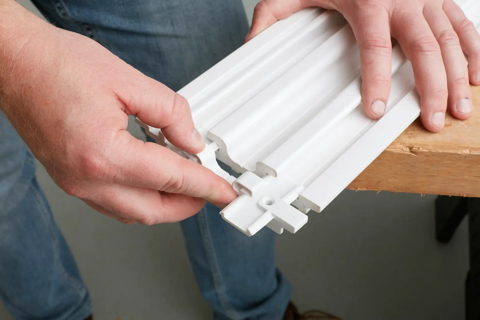STANLEY STST82610-1 white modular wall panel being assembled by hand, photography close-up.