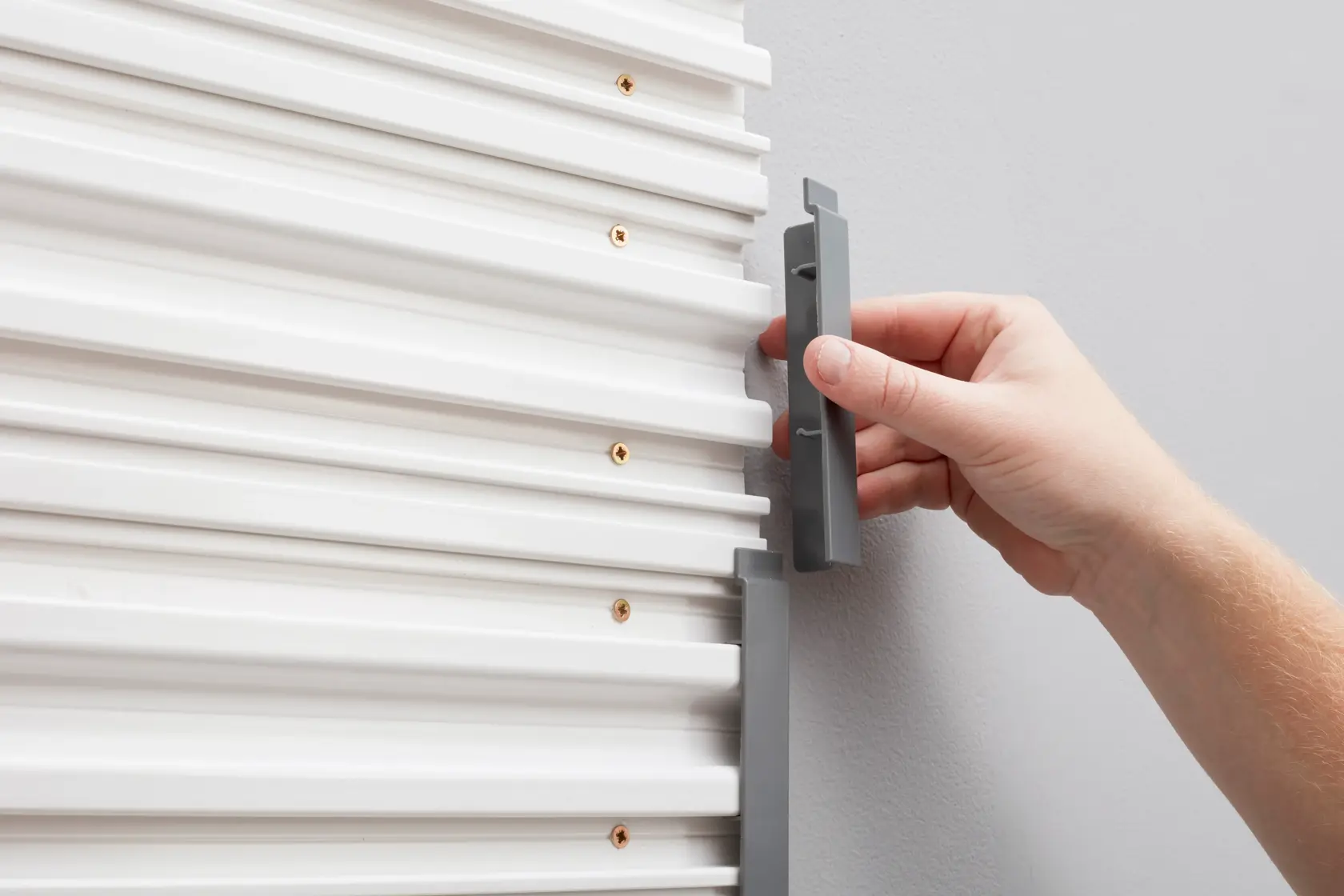 STANLEY STST82611-1 grey end cap being installed on white wall panel, close-up photography.