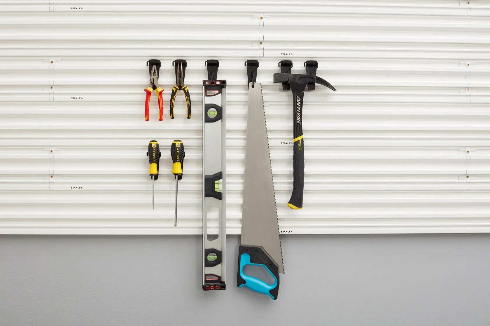 STANLEY STST82617-1 photography of garage wall panel with hand tools organized on hooks, front view.