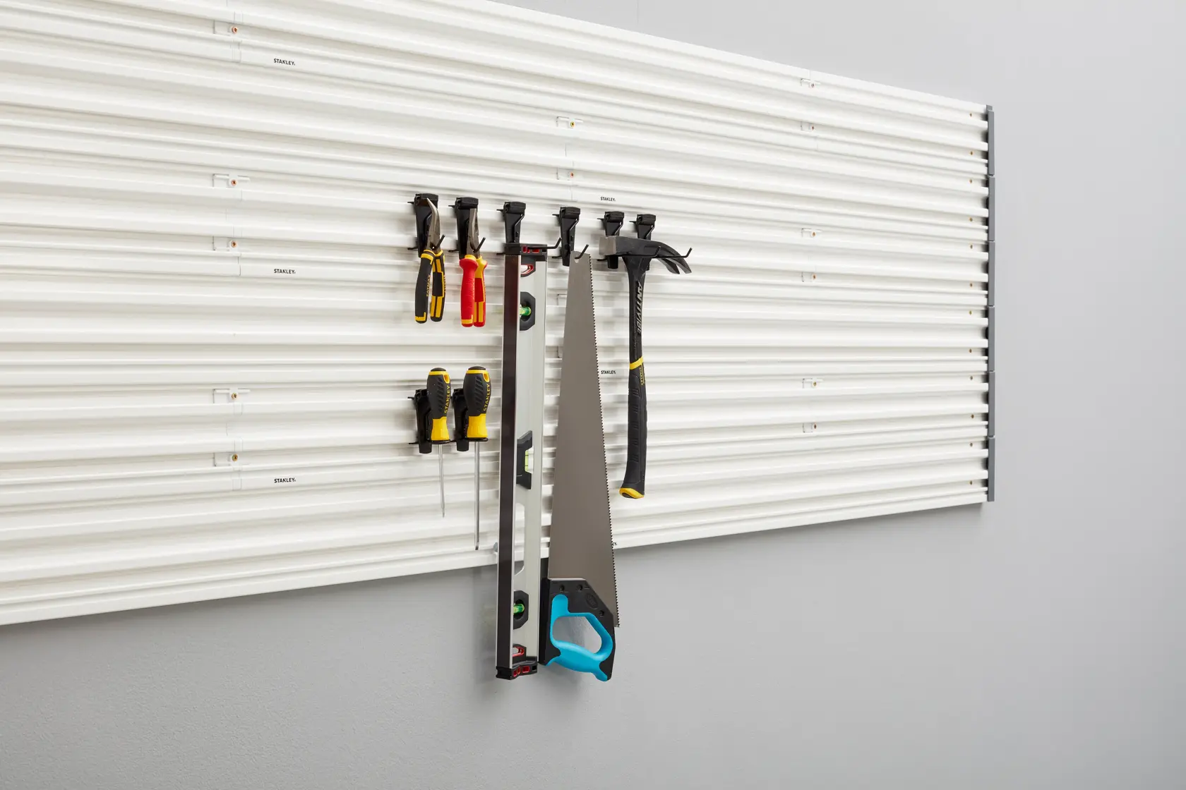STANLEY STST82617-1 wall-mounted tool organizer with assorted hand tools, front angle, photography.