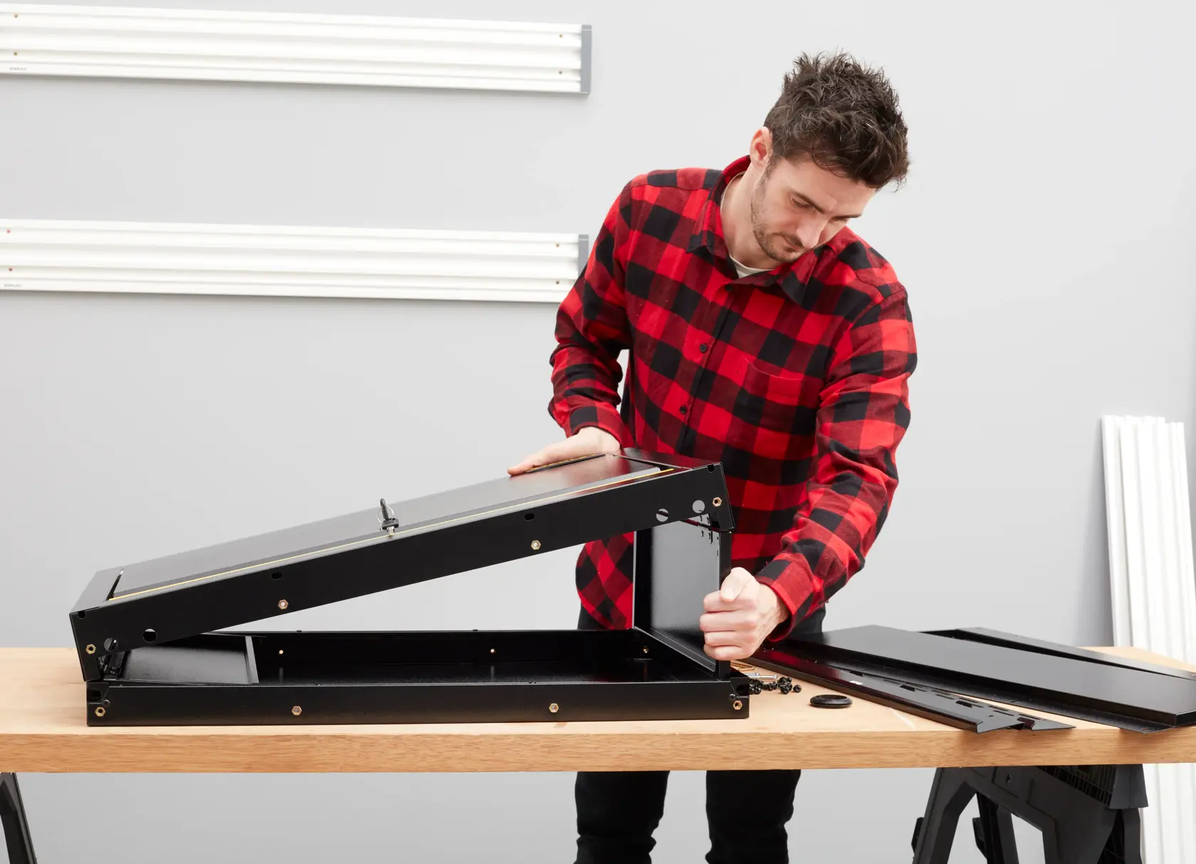 STANLEY STST97599-1 black metal storage assembly on wooden table, photography side angle.